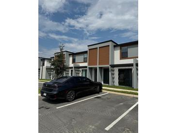 Modern townhome exterior with dark gray and brown accents at 3237 Energy Drive, Kissimmee, FL 34747