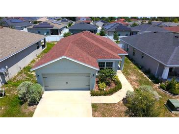 Charming single-Gathering home featuring a two-car garage and neatly landscaped front yard at 505 Pentas Ln, Haines City, FL 33844