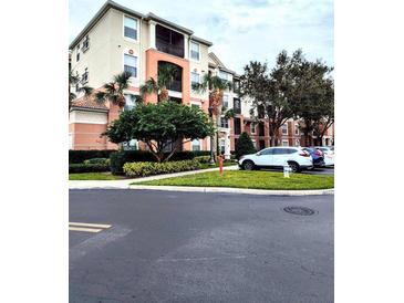 Apartment building exterior with landscaping and parking at 8296 Portofino Dr # 102, Davenport, FL 33896