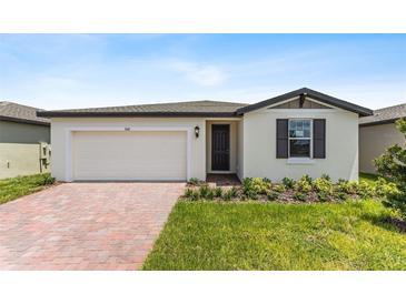 One-story house with a two-car garage and brick paver driveway at 3142 Viceroy Ct, Poinciana, FL 34759