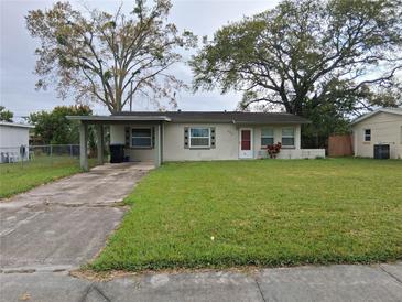 Charming single-story home with a well-maintained lawn and mature trees in a quiet neighborhood at 4824 Shoshone St, Orlando, FL 32819
