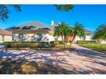 Beautiful one-story home with a large driveway and manicured landscaping at 5666 Merlin Way, St Cloud, FL 34772
