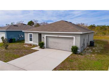 Newly constructed one-story home with attached garage and landscaped yard at 1067 Haines Dr, Winter Haven, FL 33881