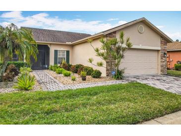Single-story home with landscaped yard and attached garage at 119 Verona Dr, Kissimmee, FL 34759