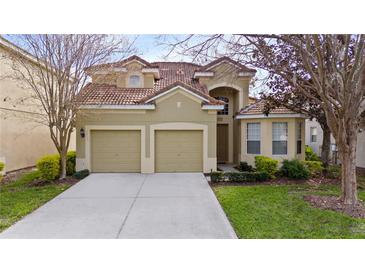 Charming two-story home with a well-manicured lawn and a two-car garage at 2615 Pawnall St, Kissimmee, FL 34747