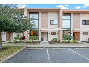 Modern townhome with sleek design and landscape at 7537 Brooklyn Dr, Kissimmee, FL 34747