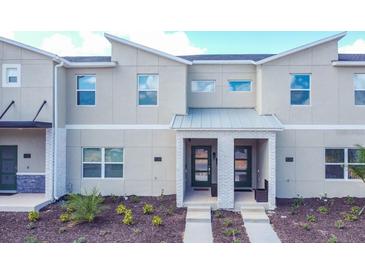 Two-story townhome with modern facade and landscaping at 1138 Kingsbarn St, Davenport, FL 33896