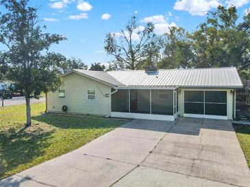 Charming home with a large driveway, screened porch, and well-maintained lawn at 2601 16Th St, St Cloud, FL 34769