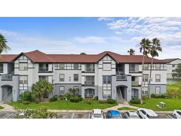 Two-story condo building with attractive exterior and landscaping at 3701 Castle Pines Ln # 3927, Orlando, FL 32839
