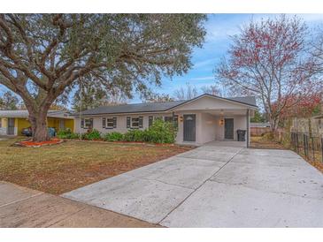 Newly renovated house with gray accents and a spacious driveway at 5265 Letha St, Orlando, FL 32811