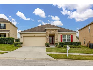 One-story house with attached garage and landscaping at 5793 Dornich Dr, Auburndale, FL 33823