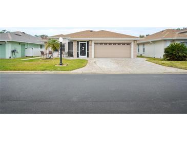 Single-story home with attached garage and landscaped yard at 580 Teesdale, Haines City, FL 33844