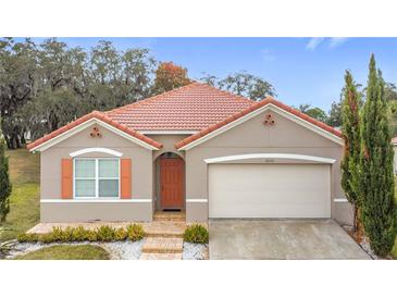 One-story house with terracotta roof and attached garage at 3033 Sangria St, Kissimmee, FL 34744