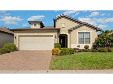 Charming single-Gathering home with a well-manicured front yard and two car garage at 605 Cantabria Dr, Davenport, FL 33837