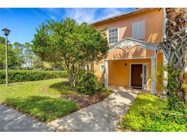 Inviting exterior of a two-story home with landscaping and walkway at 801 New Providence # B19/U801, Davenport, FL 33897