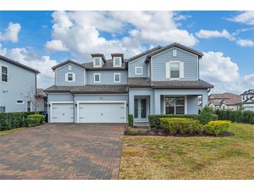 Two-story house with three-car garage and landscaped front yard at 8024 Leaf Grove Cir, Orlando, FL 32836