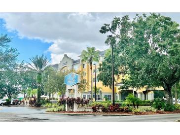 Hotel exterior with landscaping and signage at 3000 Maingate Ln # 209, Kissimmee, FL 34747