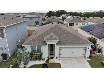 Aerial view of a house and surrounding neighborhood at 606 Tortugas St, Haines City, FL 33844