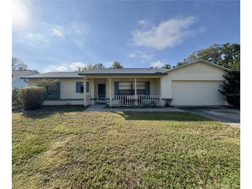 Single-story house with carport and well-maintained lawn at 219 Macon Way, St Cloud, FL 34769