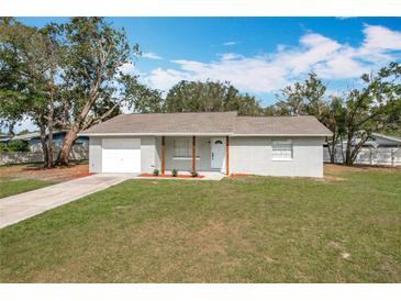 Charming single-story home with a well-maintained lawn and an attached garage at 980 Pinecrest Dr, Bartow, FL 33830