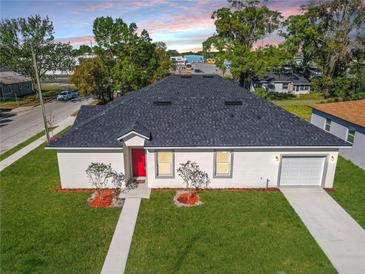 Beautiful single Gathering home featuring a new roof, a well manicured lawn, and an attached garage at 1022 Mack Ave, Orlando, FL 32805