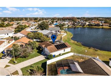 Aerial view of a single-Gathering home with a pool and lake access at 2302 Aberdeen Ct, Kissimmee, FL 34743