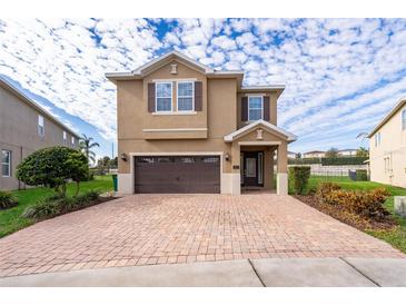 Two-story house with brown brick driveway and landscaping at 250 Pendant Ct, Kissimmee, FL 34747