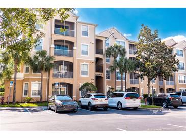 Three-story condo building with ample parking and landscaping at 2774 Almaton Loop # 305, Kissimmee, FL 34747