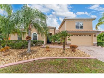 Two-story house with landscaped yard and two-car garage at 4010 Navigator Way, Kissimmee, FL 34746