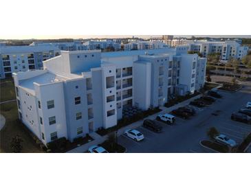 Apartment building with modern design, multiple floors, and ample parking at 3180 Paradox Cir # 102, Kissimmee, FL 34746