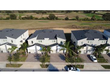 An aerial view of townhomes overlooking the community golf course at 853 Ocean Course Ave # 853, Davenport, FL 33896