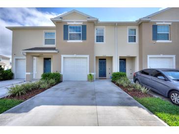 Inviting townhouse exterior with well-manicured landscaping and private driveway at 2352 Tay Wes Dr, St Cloud, FL 34771