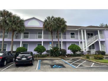 Purple two-story building with balconies, parking, and landscaping at 3133 Sun Lake Ct # B, Kissimmee, FL 34747