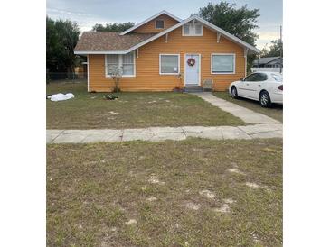Cute orange house with a yard, and driveway at 342 E Tillman Ave, Lake Wales, FL 33853