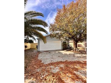 Newly renovated home with a spacious front yard and driveway at 656 Oakford Way, Orlando, FL 32811