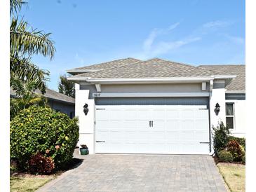 House exterior featuring a two-car garage and a paved driveway at 7637 Sand Pierre Ct, Kissimmee, FL 34747