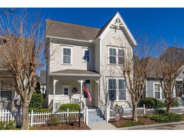Charming two-story home with a wrap-around porch and white picket fence at 836 Lake Evalyn Dr, Celebration, FL 34747