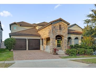 Two-story house with stone accents and a two-car garage at 14657 Winter Stay Dr, Winter Garden, FL 34787