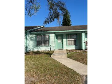 Charming single-story home with manicured lawn and walkway leading to the front door at 1919 Bentley Blvd, Kissimmee, FL 34741