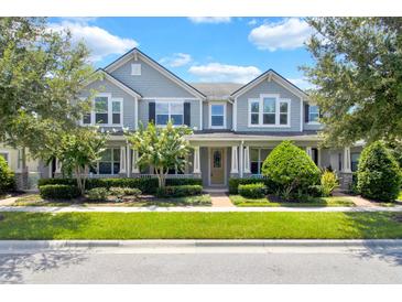 Charming two-story home with well-manicured lawn, landscaping, covered porch, and inviting entrance at 2617 Amati Dr, Kissimmee, FL 34741