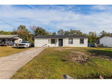 Newly renovated home with a white exterior and black accents at 2959 Old Dixie Hwy, Kissimmee, FL 34744