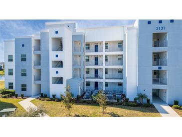 Modern building exterior, featuring light blue and white accents at 3131 Paradox Cir # 401, Kissimmee, FL 34746