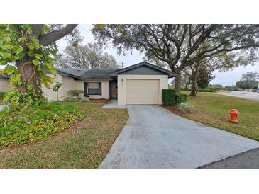 Cute one-story home with attached garage and landscaped yard at 56 Buck Cir, Haines City, FL 33844