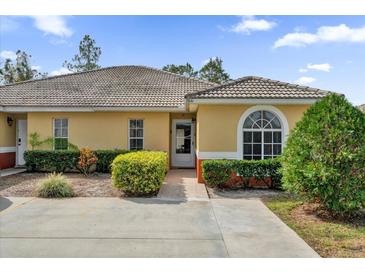 Inviting exterior of a single-story home with a well-manicured lawn at 760 Lake Marion Golf Resort, Poinciana, FL 34759
