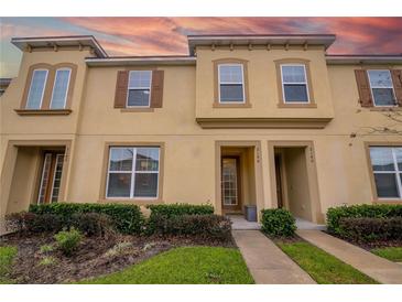 Inviting two-story townhome featuring a well-manicured lawn and a warm, inviting facade at 2186 Fleming Mist Pl, Kissimmee, FL 34747