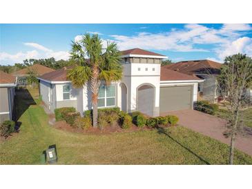 Single-story home with gray garage door and brick paver driveway at 362 Via Torrente Dr, Kissimmee, FL 34759