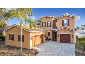 Beautiful Mediterranean style home with a three car garage and lush landscaping at 3841 Golden Knot Dr, Kissimmee, FL 34746