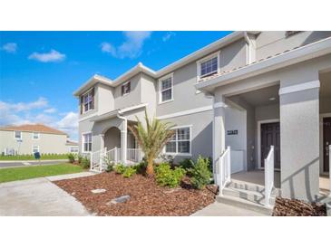Modern 2 story home with gray exterior, walkway, and landscaping at 4976 Windermere Ave, Kissimmee, FL 34746