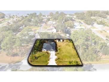 Aerial view of a beautifully landscaped home with a pristine lawn and a well-maintained exterior at 1150 Eden Dr, St Cloud, FL 34771