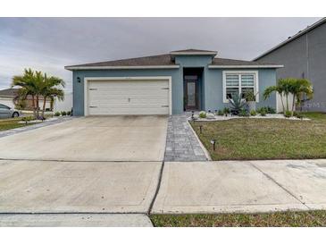 Curb appeal abounds at this charming one-story home, featuring a landscaped yard and two-car garage at 1836 Delrose Rd, Kissimmee, FL 34744
